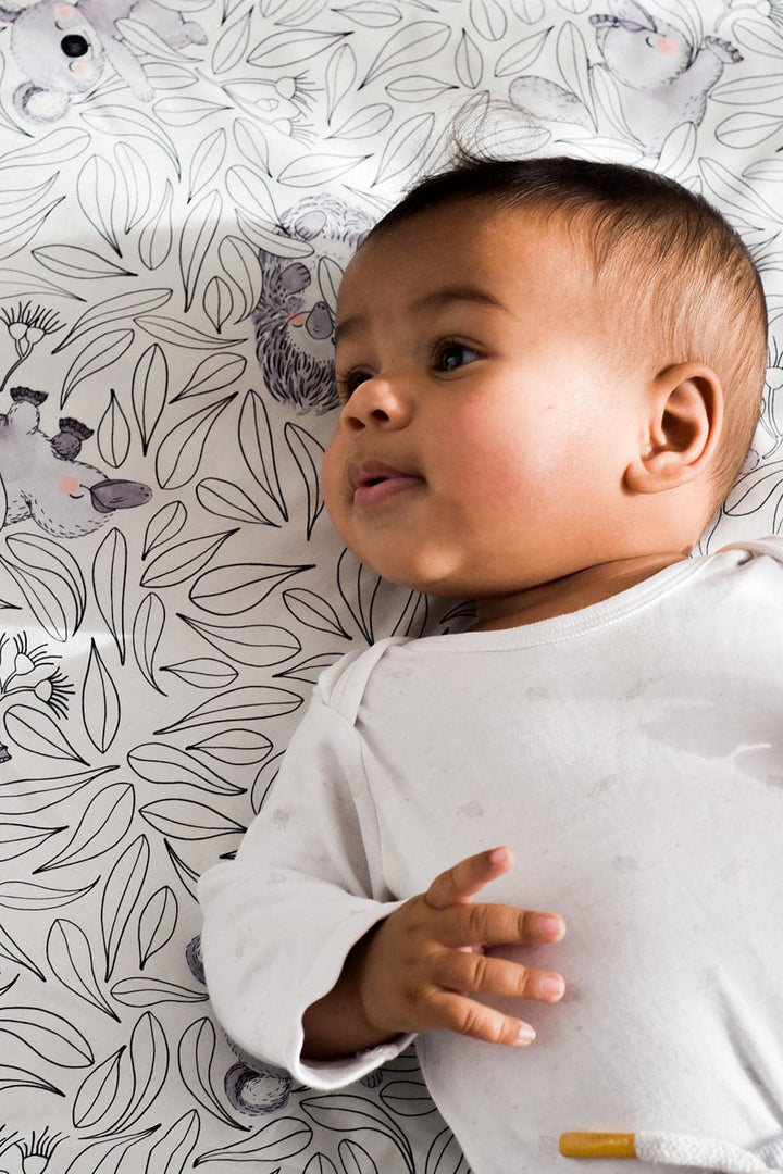 Smiling Baby on a Cuddly Faces Baby Play Mat