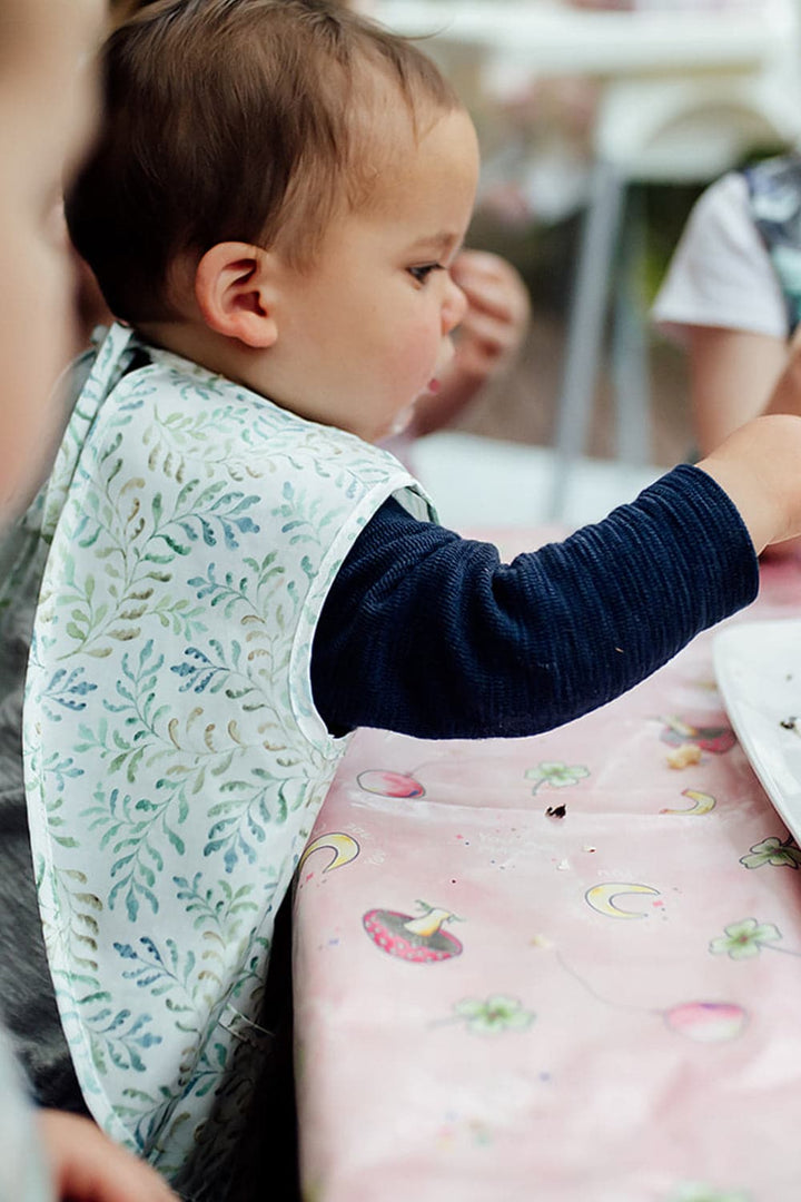 Power of Positivity Marmalade Lion Amongst the Ferns Feeding Bib & Splat Mat table